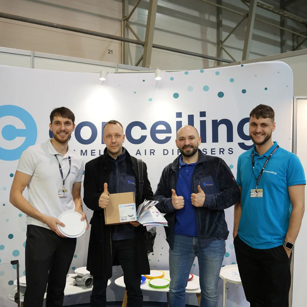 Conceiling team with partners at a construction trade exhibition